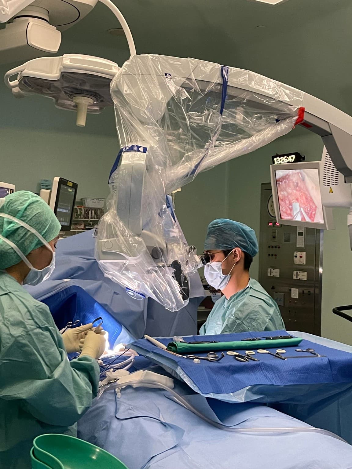 Operating-room team working with a surgical microscope